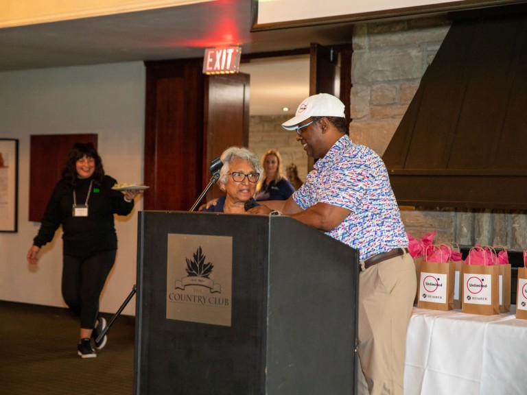 Two people at the podium in the dining room