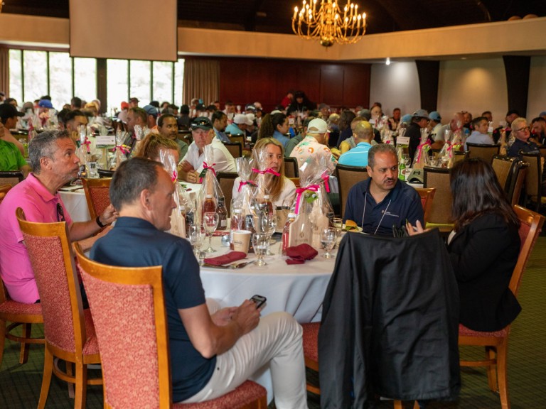 People sitting at tables in country club dining room