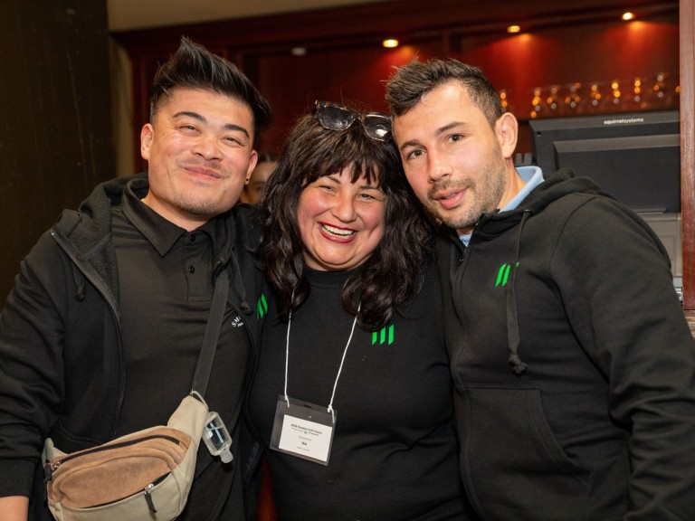 Three people smiling for camera