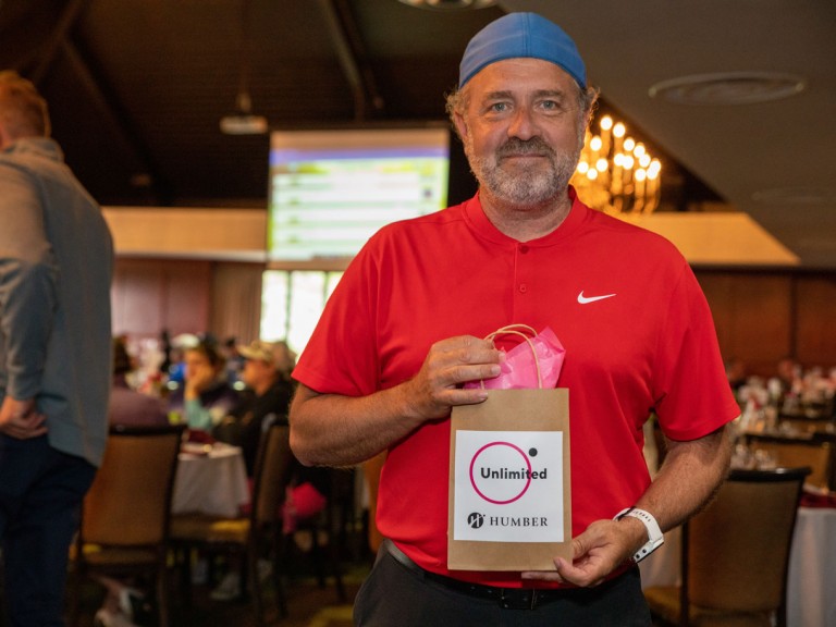 Person holding brown paper gift bag