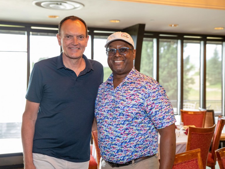 Christ Whitaker next to person posing for photo