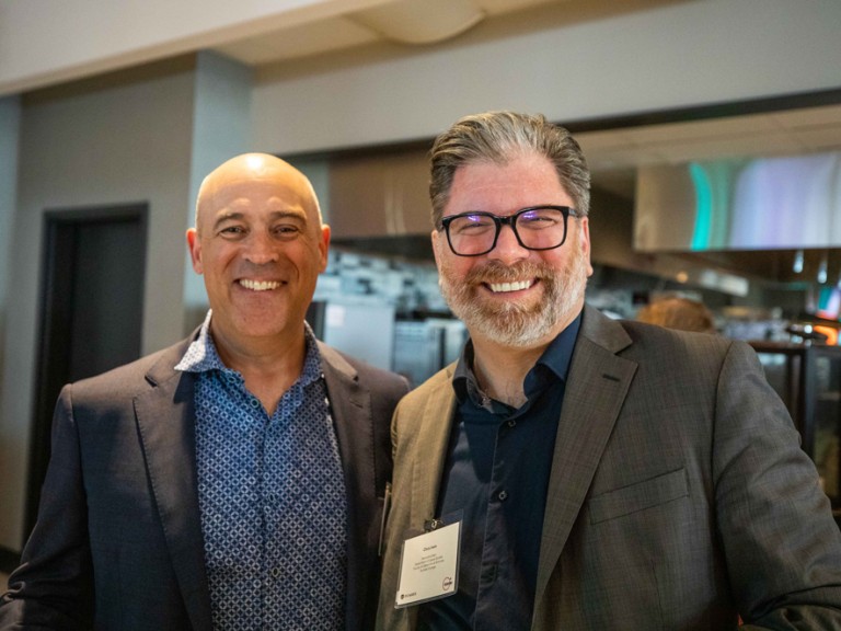 Two men smiling for camera