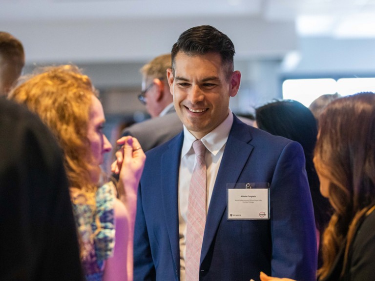 Man in suit among people