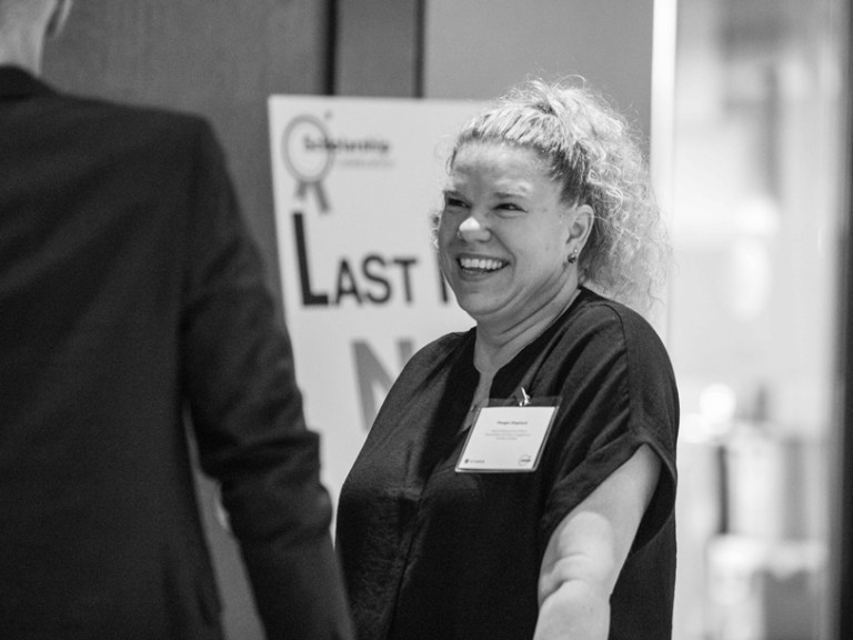 Black and white photo of woman smiling at someone