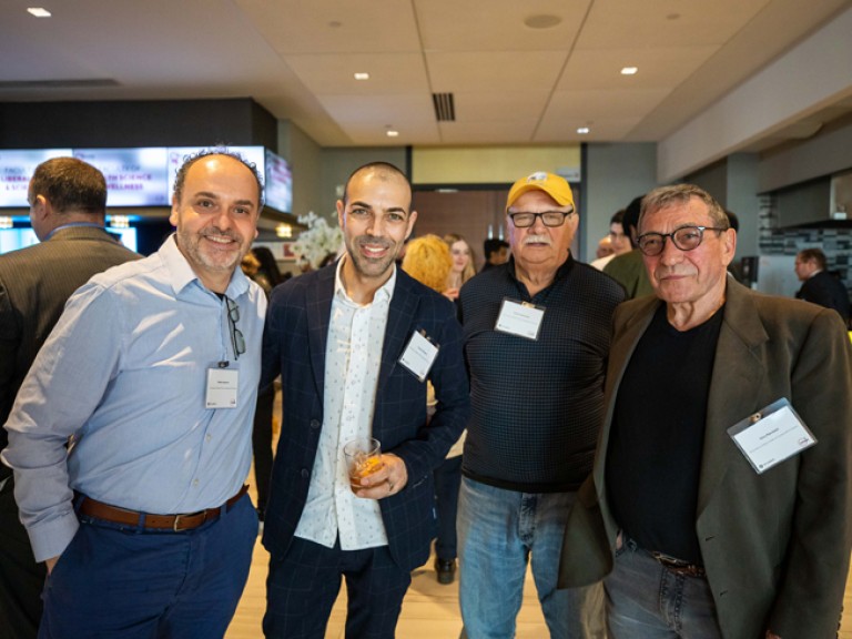 Four men standing for photo