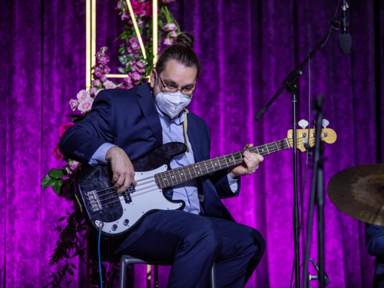 Guitar player seated on stage