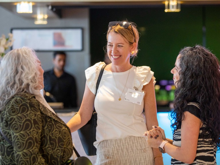 Three women talking and smiling