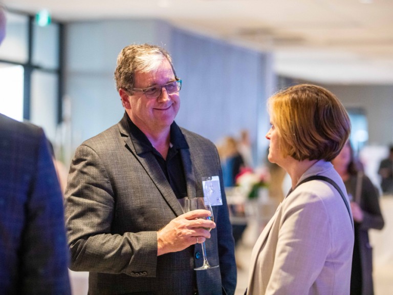 Two people talking at event reception