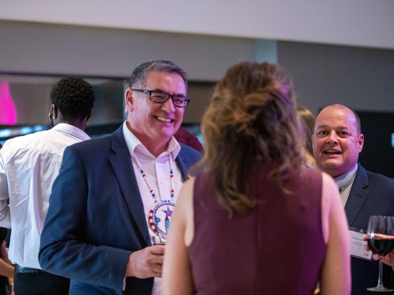 Group of people talking at event reception