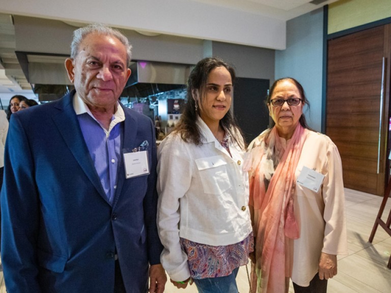 Three people posing for picture