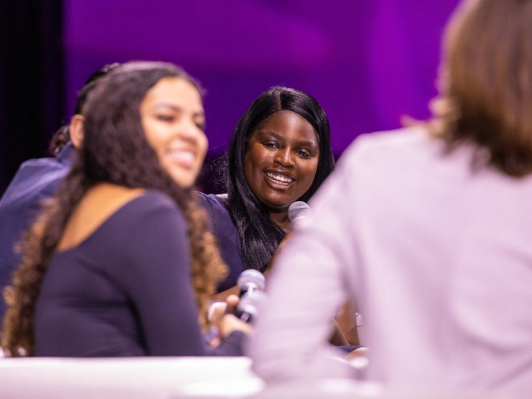 People on stage smiling at each other