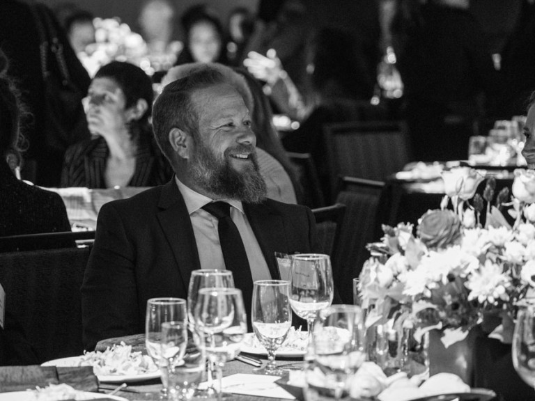 Person at dining table smiling