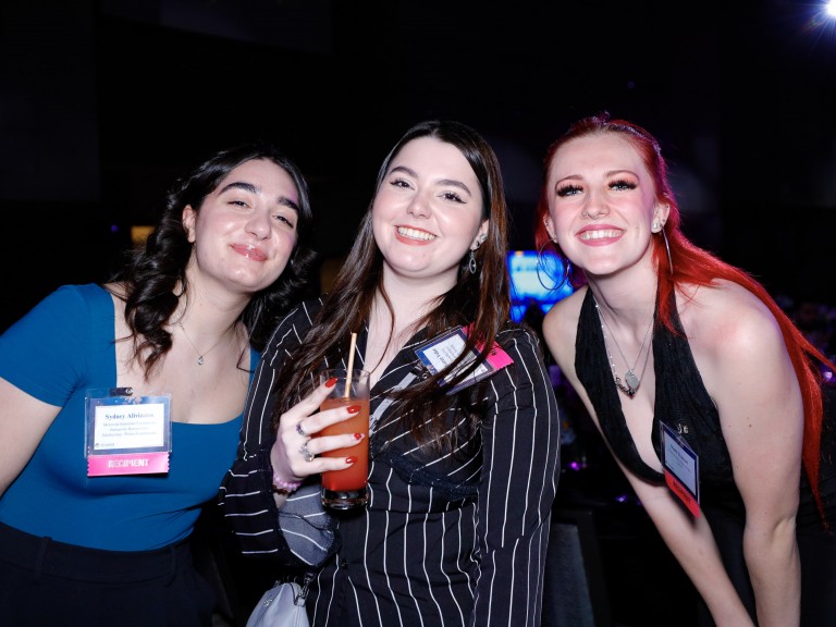 Three people posing for photo
