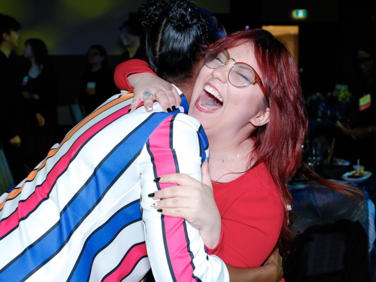 People hugging and laughing
