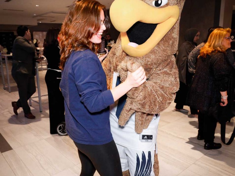 Person dancing with mascot