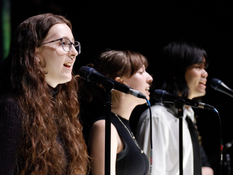 Three people singing together