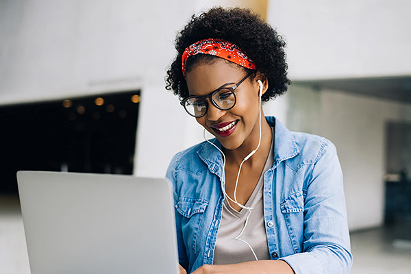 woman using laptop with headphones