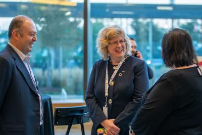 Ann Marie Vaughan smiles as she chats with two people at an event at Humber College.