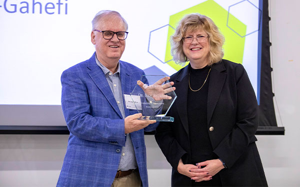 Dr. Dan Andreae holding a plaque