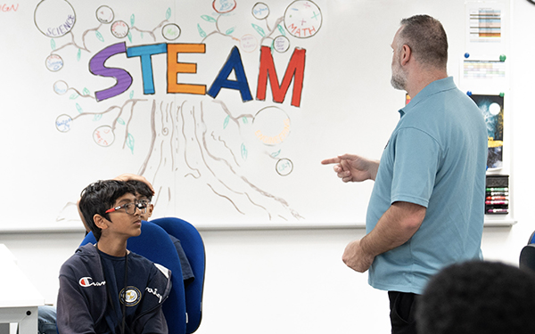 Teacher with kids, STEM on board