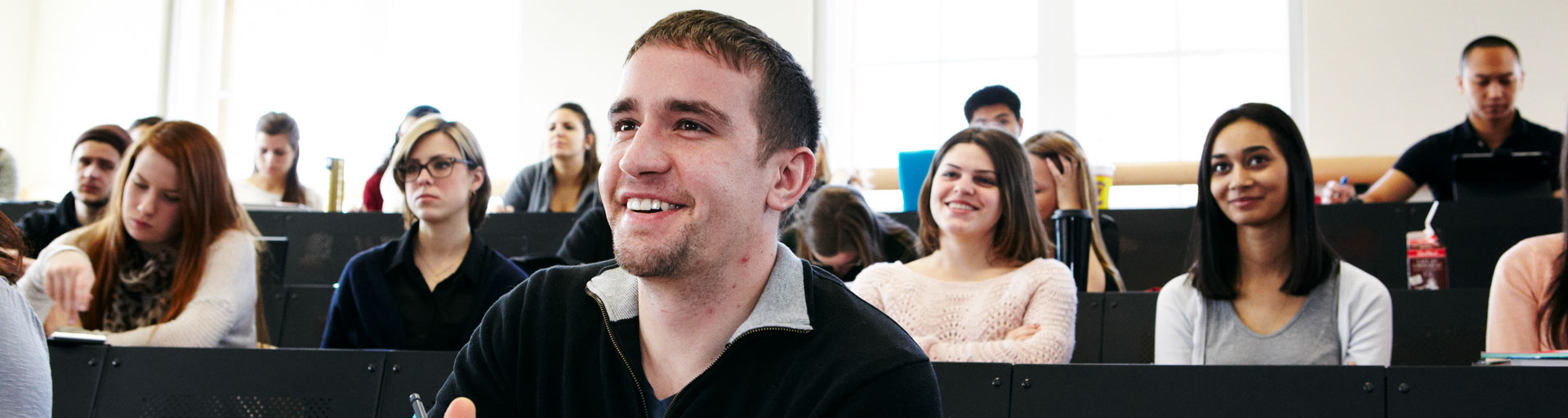 Students smiling in lecture hall