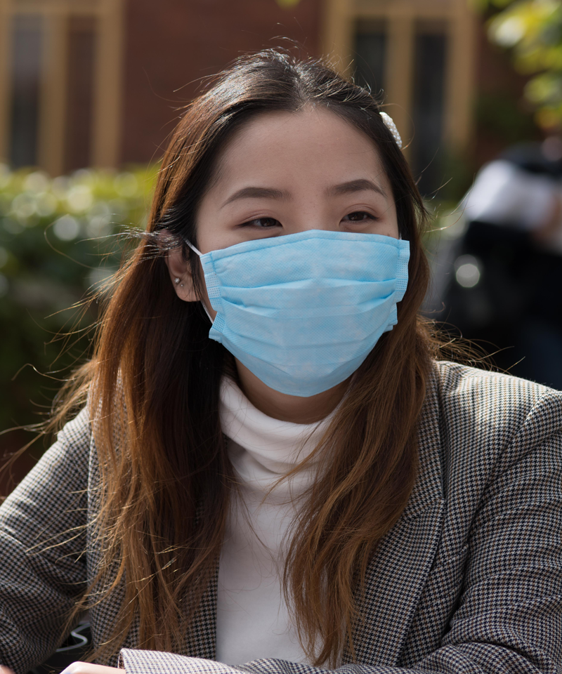 student wearing face mask outdoors