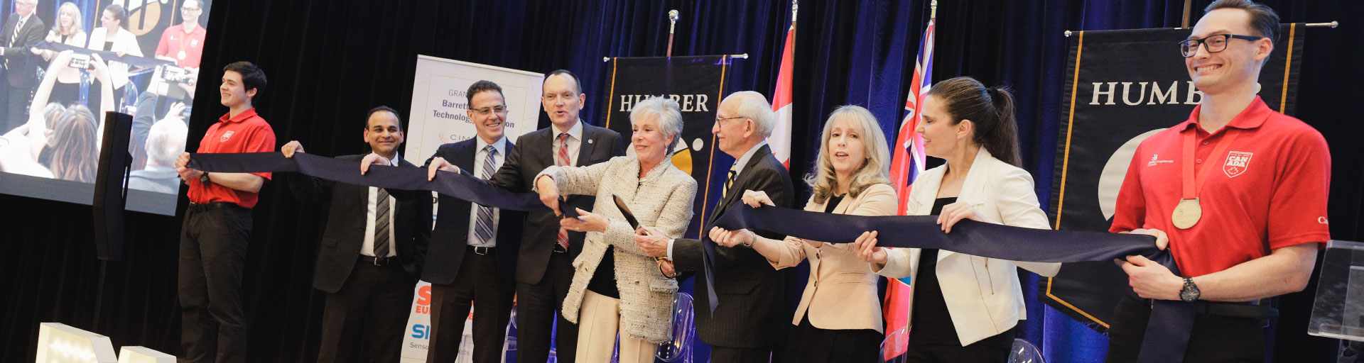 group of people cutting ceremonial ribbon