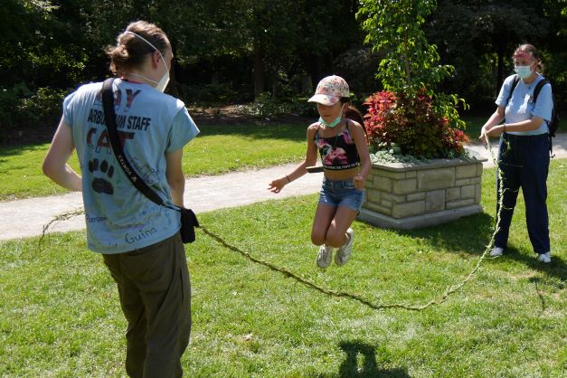A camper jumps rope with rope made from dog-strangling vine