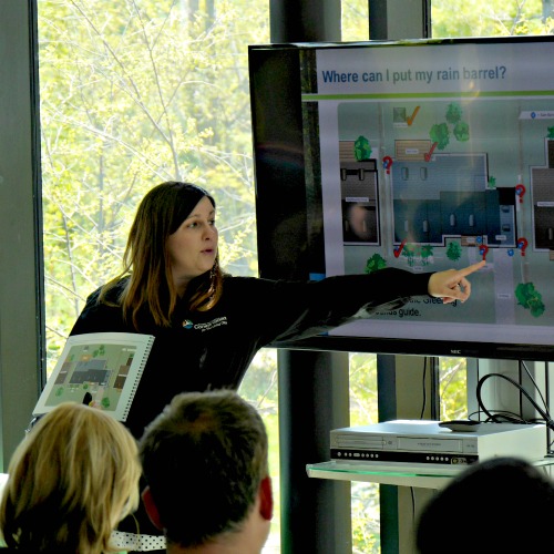 A TRCA instructor points to a diagram on a TV screen