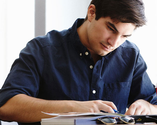 person sitting and writing