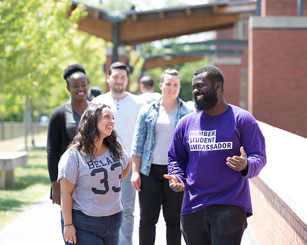 students walking outside touring the campus