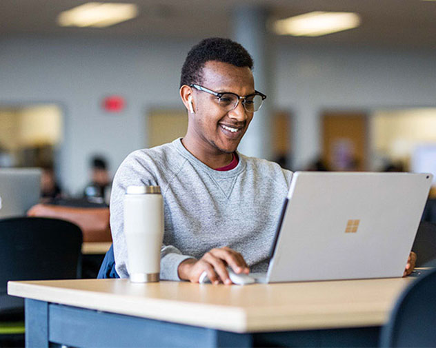 person sitting and using a laptop