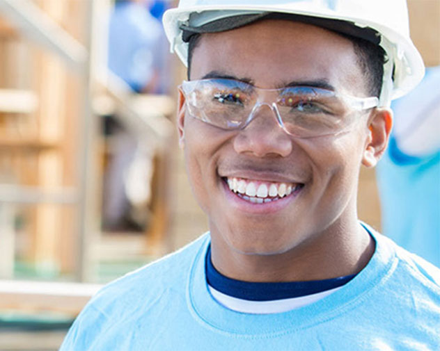 student smiling on construction site