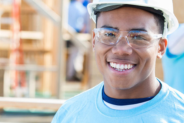 student smiling on construction site