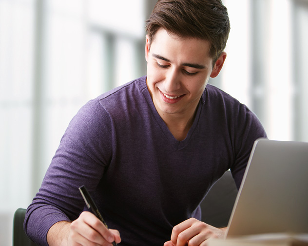 person sitting and writing