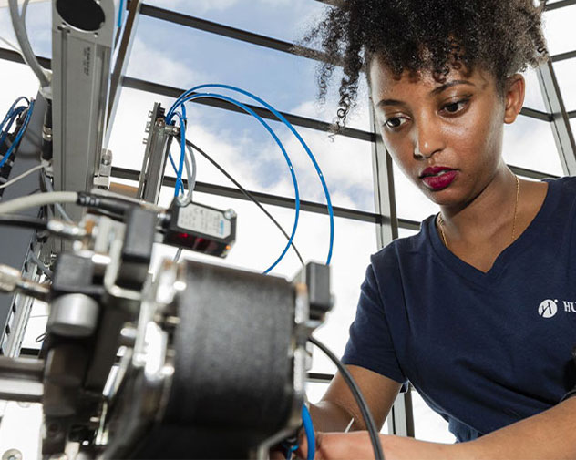 student working on a machine