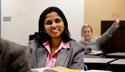Woman wearing a suit learning in a classroom