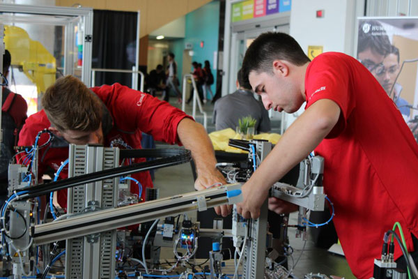 students working on machine