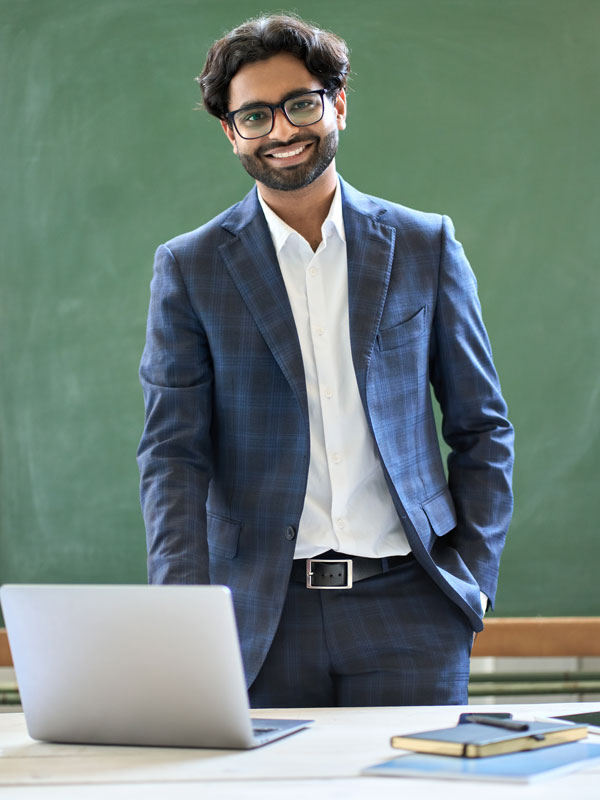 Teacher standing behind desk