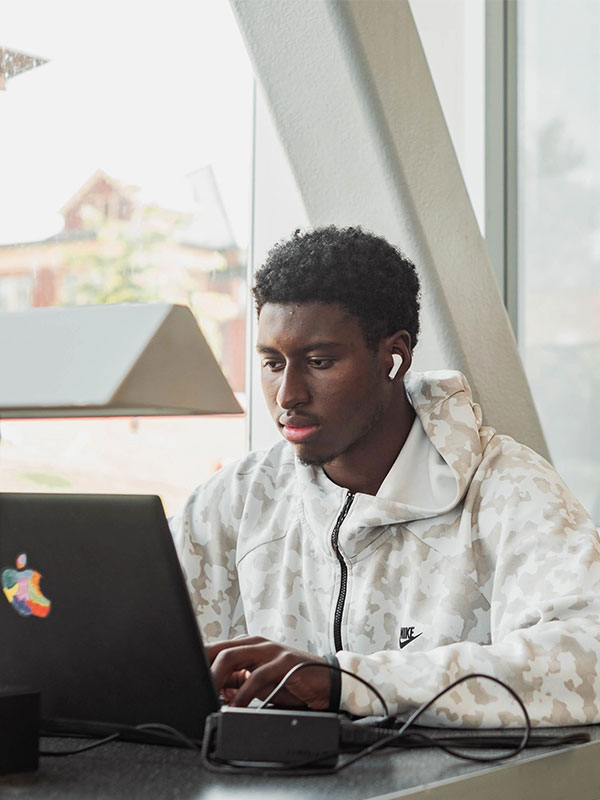 Person sitting at a table using a laptop