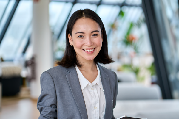 Salesperson dressed in business attire smiling for a corporate style photo