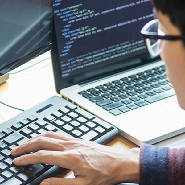 Person writing code on computer