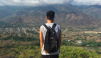Student looking a view from a mountain