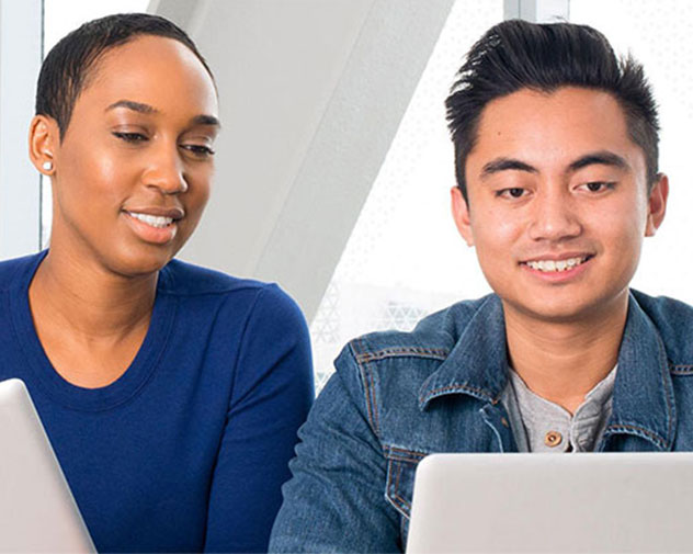 two people sitting down looking at computer