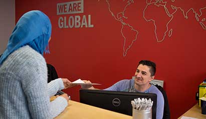 receptionist helping student a international desk