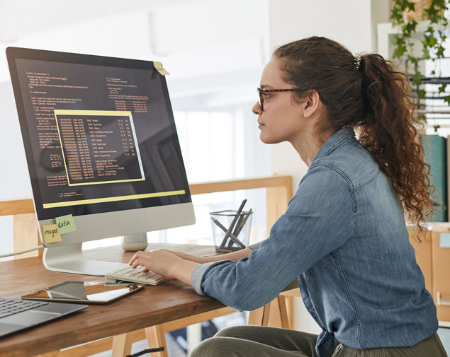 Person looking at code on computer monitor