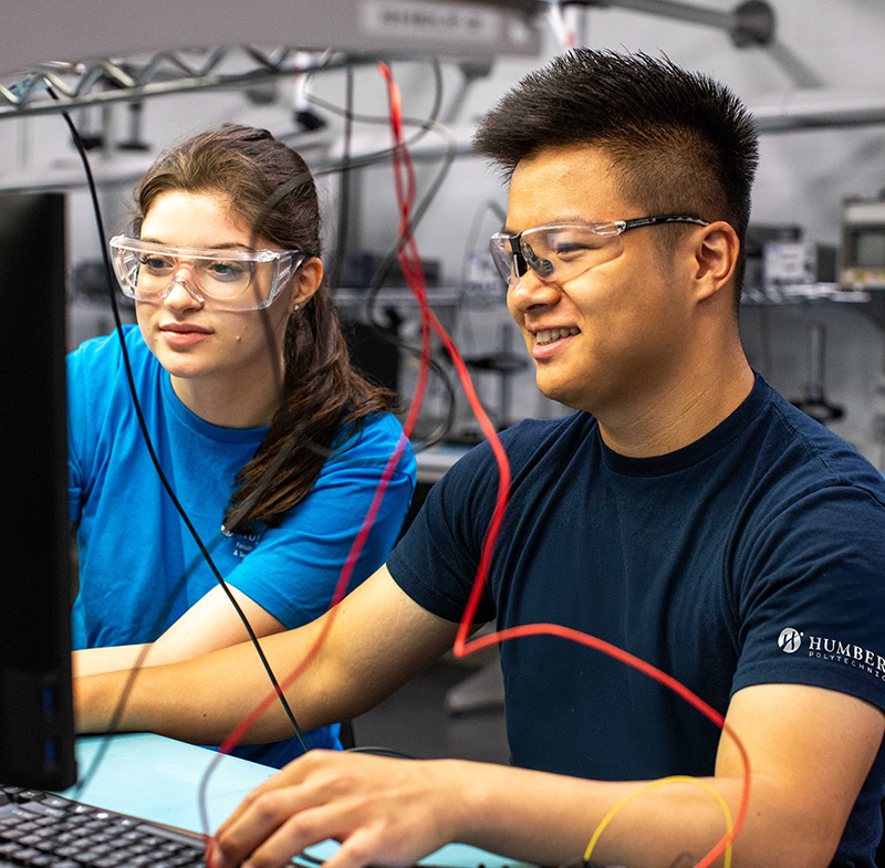 2 people looking at a computer screen