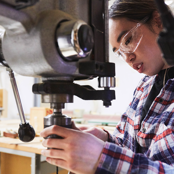 student working with heavy machinery