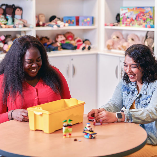 two students playing in the play lab