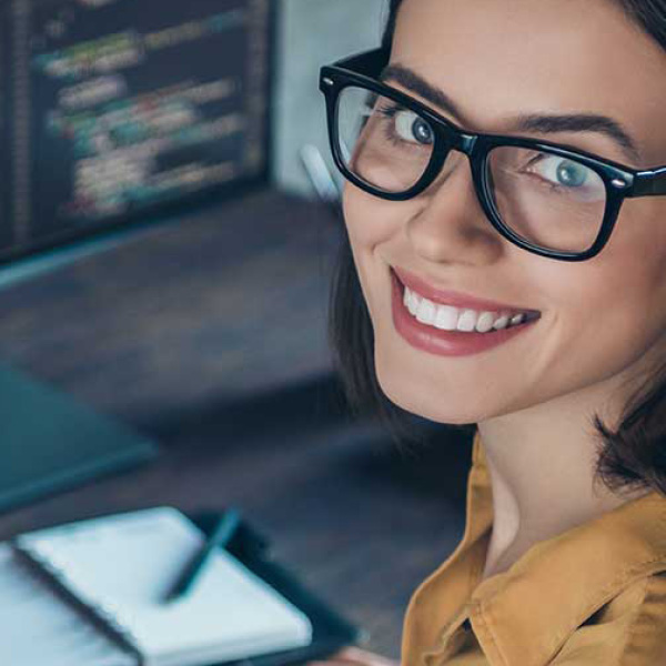 smiling woman writing code